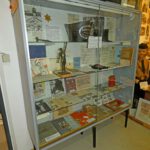 Museum showcase with documents, books, and objects from everyday life in Nazi Germany