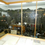 Bundeswehr-themed exhibition showing soldier uniforms, equipment, and a military workspace in a museum display